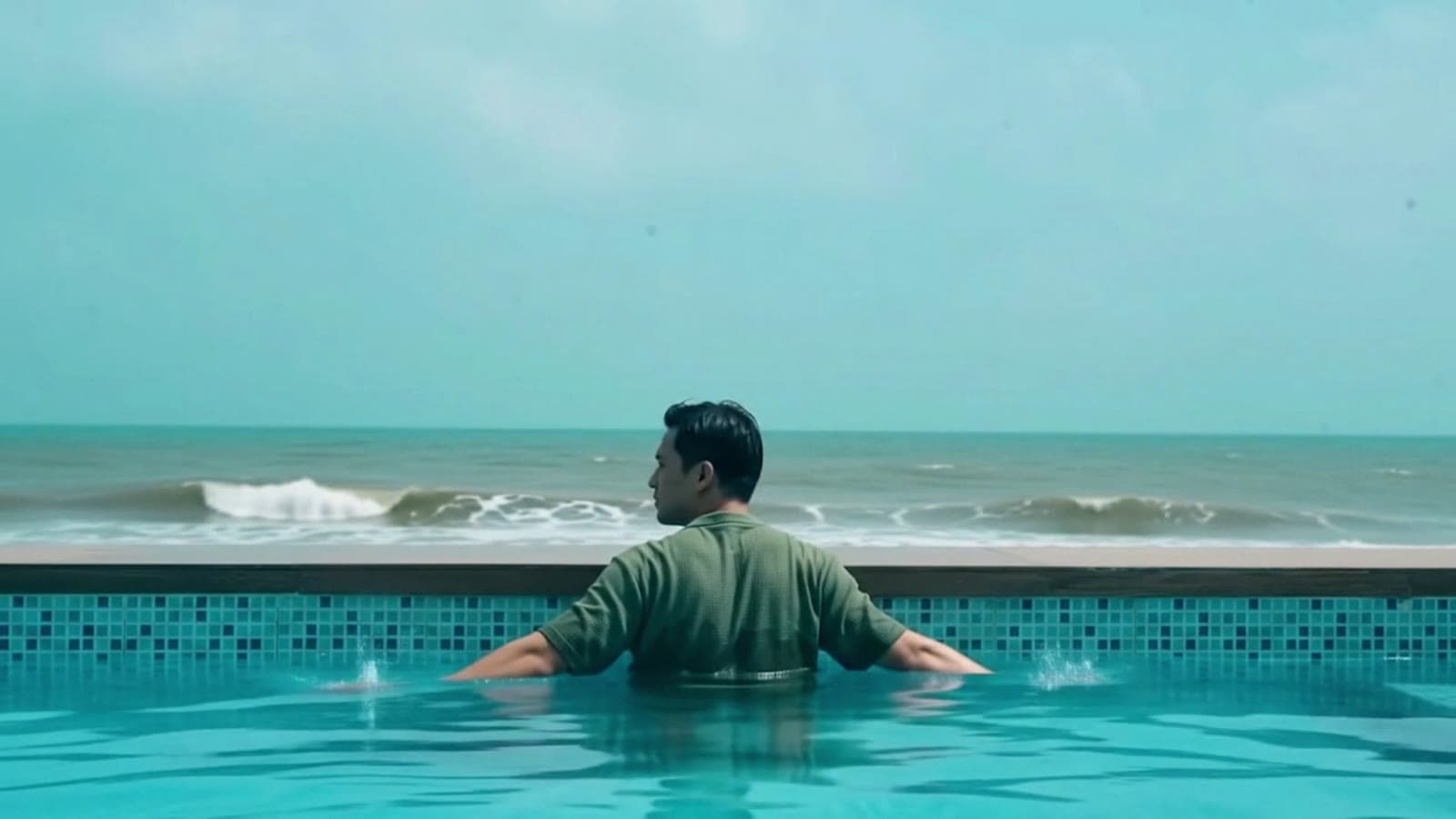 Man standing in an infinity pool facing the ocean, from a Ziml AI campaign