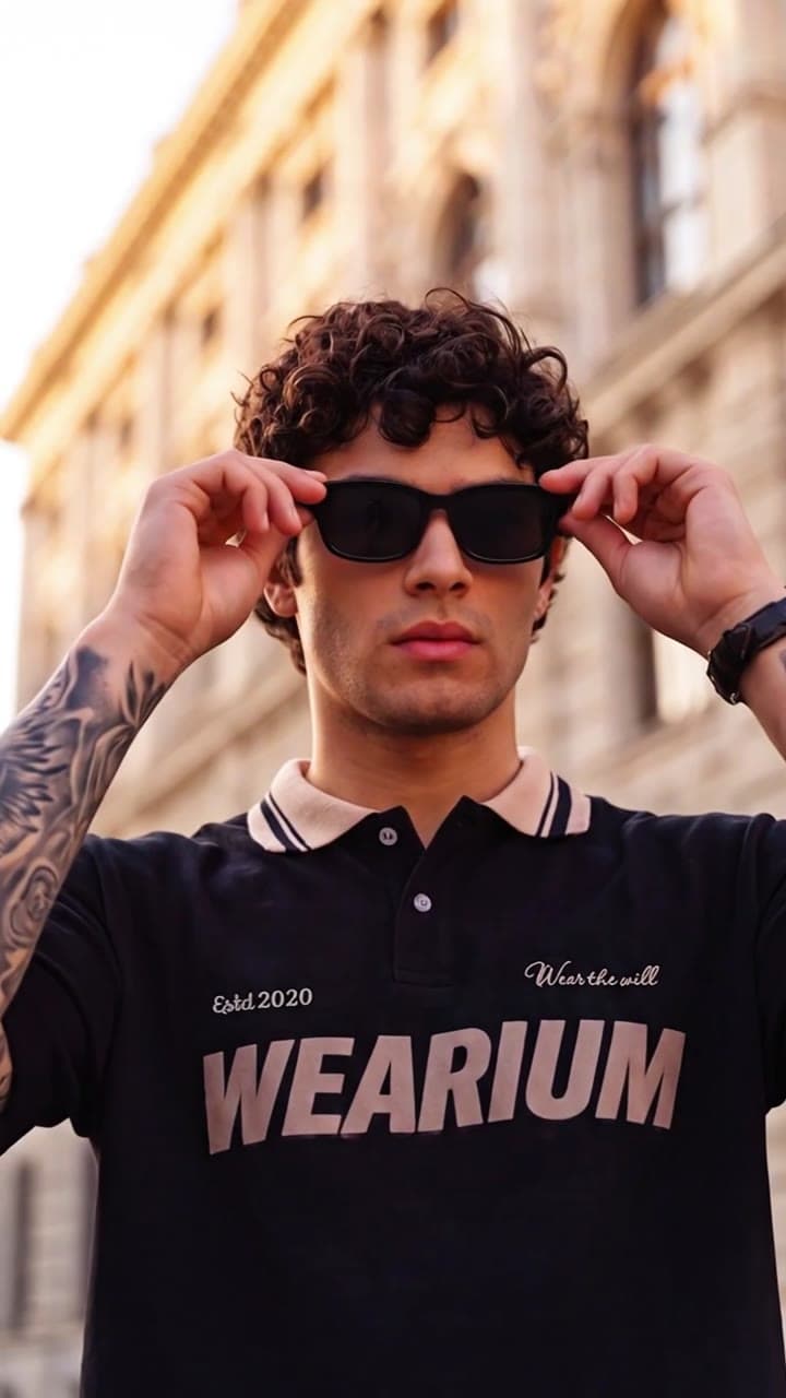 Model in a Wearium polo adjusting sunglasses